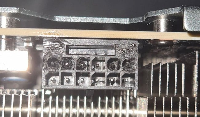 Close up photo of a slightly melted and damaged RTX 4090 GPU connector port 