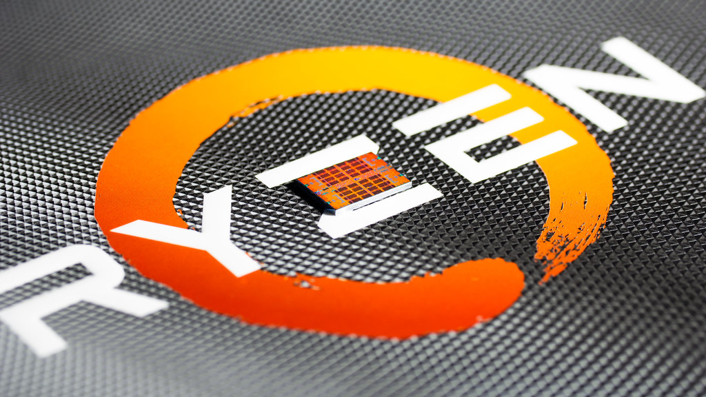 Close up image of an AMD Ryzen chip sat atop the Ryzen logo